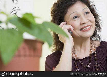 Close-up of a senior woman using a mobile phone and smiling