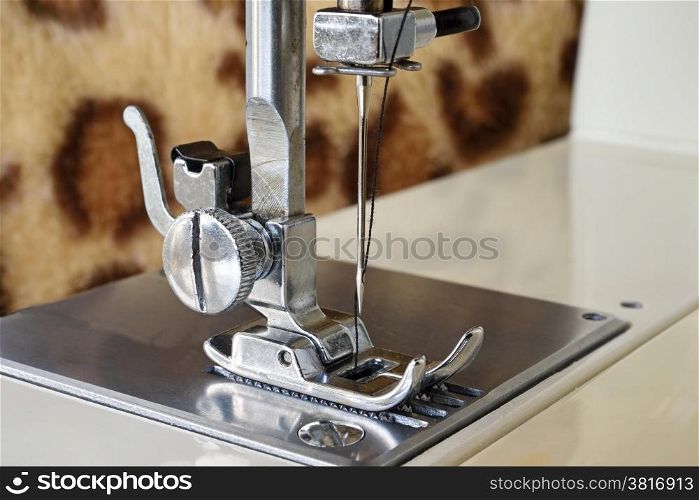 Close up of a sewing machine with the needle