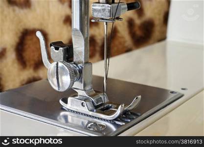 Close up of a sewing machine with the needle