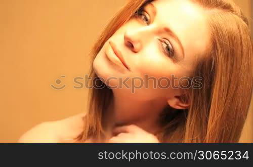 Close-up of a sexy redhead woman with a dreamy facial expression.