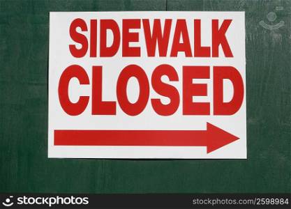 Close-up of a sidewalk closed sign