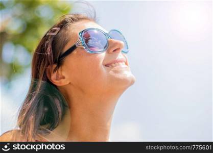 Close up of a smiling relaxed young blond looking the sun