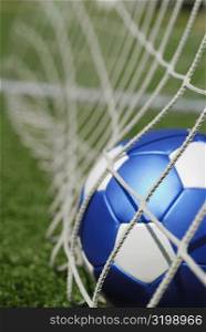 Close-up of a soccer ball in a net