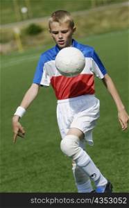 Close-up of a soccer player playing with a soccer ball