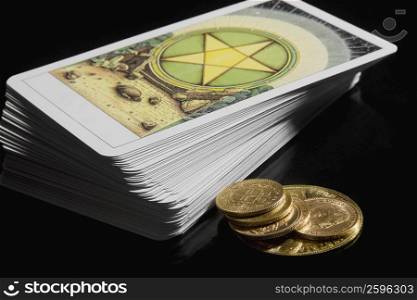Close-up of a stack of tarot cards with coins
