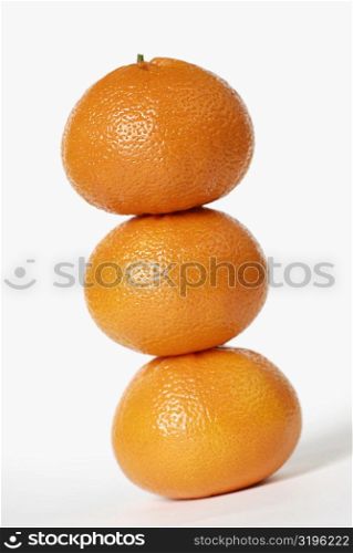 Close-up of a stack of three oranges
