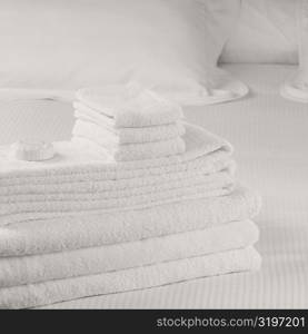 Close-up of a stack of towels on the bed
