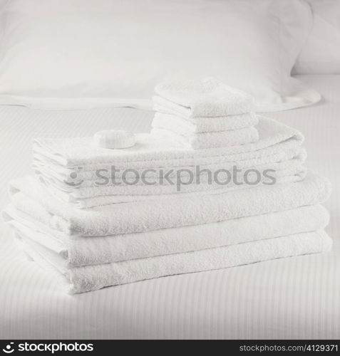 Close-up of a stack of towels on the bed