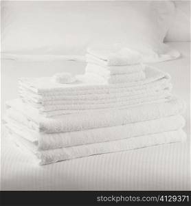 Close-up of a stack of towels on the bed