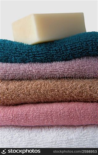 Close-up of a stack of towels with a bar of soap