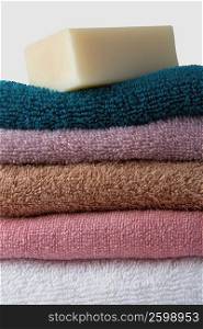Close-up of a stack of towels with a bar of soap