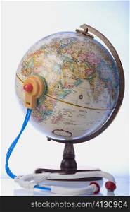 Close-up of a stethoscope and a globe