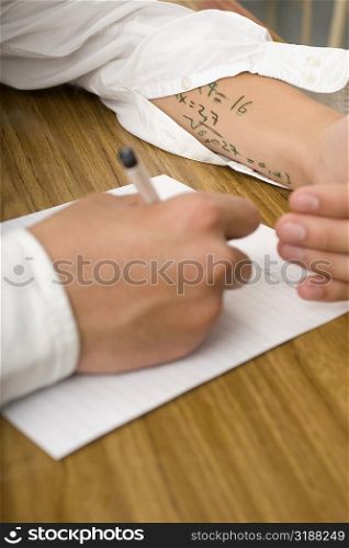 Close-up of a student copying in an examination