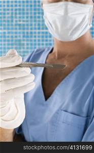 Close-up of a surgeon holding a scalpel