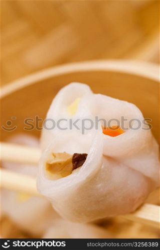 Close-up of a sushi roll being held in chopsticks