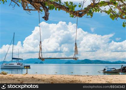 close-up of a swing on a tree in the tropics against the sea, Thailand