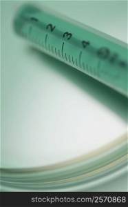 Close-up of a syringe with a petri dish