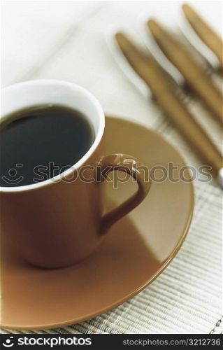 Close-up of a tea cup with pens