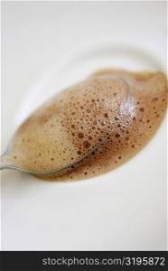 Close-up of a teaspoon in a cup of coffee