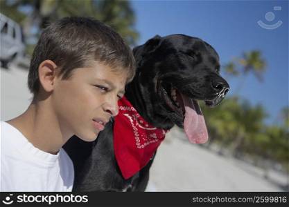 Close-up of a teenage boy and a dog