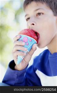 Close-up of a teenage boy eating an ice-cream cone