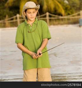 Close-up of a teenage boy holding a fishing rod