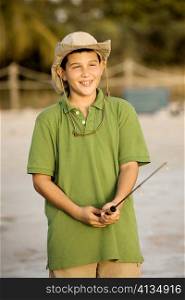 Close-up of a teenage boy holding a fishing rod