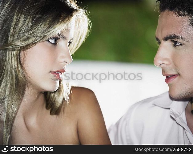 Close-up of a teenage boy looking at a young woman
