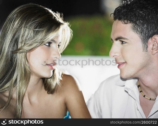 Close-up of a teenage boy looking at a young woman