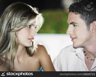 Close-up of a teenage boy looking at a young woman