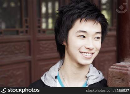 Close-up of a teenage boy looking away smiling
