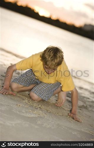 Close-up of a teenage boy playing in sand