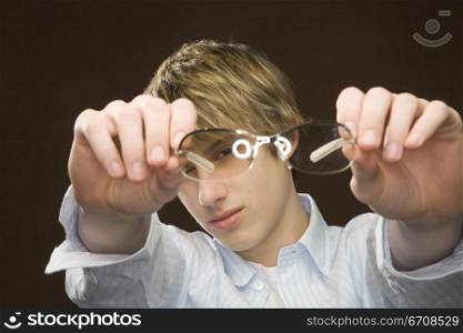 Close-up of a teenage boy showing eyeglasses