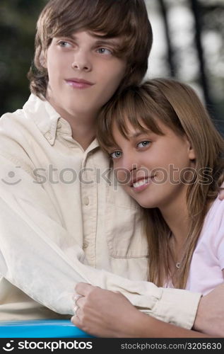 Close-up of a teenage couple embracing each other