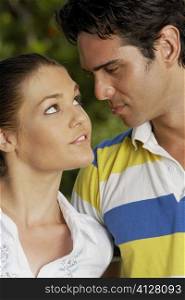 Close-up of a teenage girl and a young man looking at each other