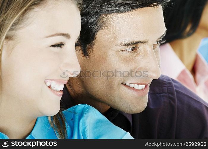 Close-up of a teenage girl and a young man smiling