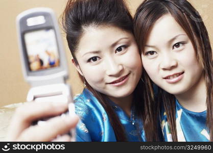 Close-up of a teenage girl and a young woman taking a photograph of themselves