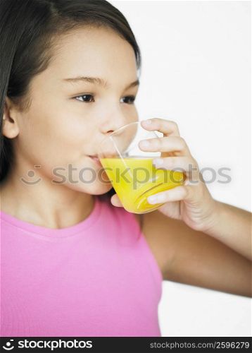 Close-up of a teenage girl drinking juice