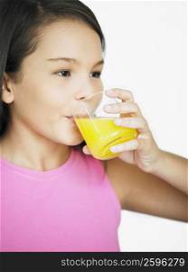 Close-up of a teenage girl drinking juice