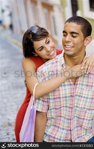 Close-up of a teenage girl embracing a young man from behind