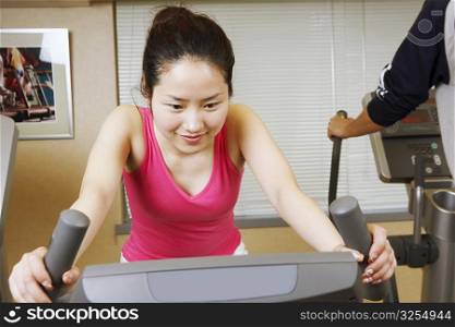 Close-up of a teenage girl exercising on an exercise bike