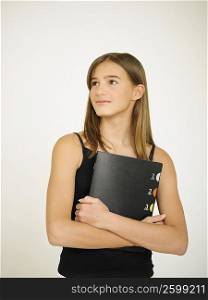 Close-up of a teenage girl holding a file