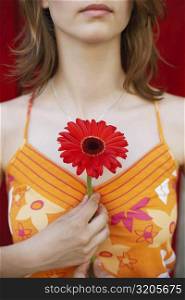 Close-up of a teenage girl holding a flower