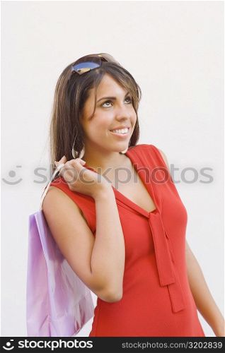 Close-up of a teenage girl holding a shopping bag