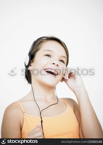 Close-up of a teenage girl listening to music