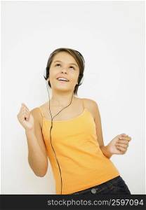 Close-up of a teenage girl listening to music and dancing