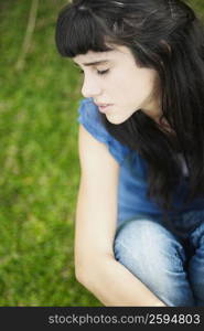 Close-up of a teenage girl sitting with her eyes closed