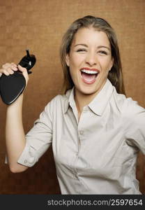 Close-up of a teenage girl smiling and holding a sandal