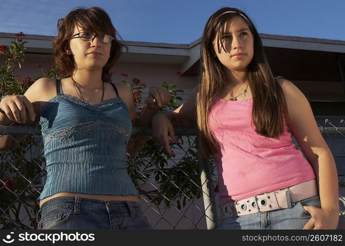 Close-up of a teenage girl standing with her sister