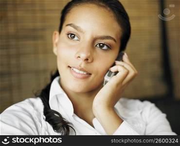 Close-up of a teenage girl talking on a mobile phone
